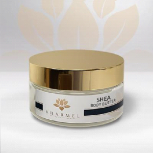 A jar of shea body butter sitting on top of a table.
